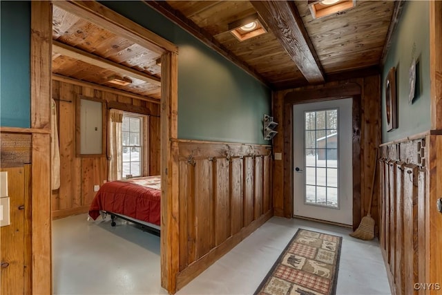 doorway with wood ceiling, electric panel, and wood walls