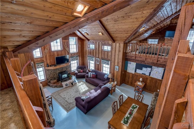 living room featuring wooden walls, beam ceiling, high vaulted ceiling, and wooden ceiling