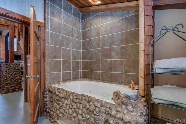 bathroom with a bathing tub and wood ceiling