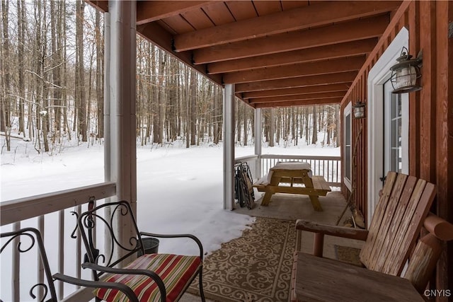 view of snow covered back of property