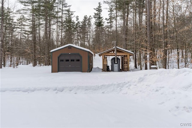 exterior space featuring a garage and an outbuilding