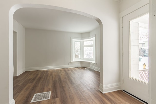 spare room with dark wood-type flooring