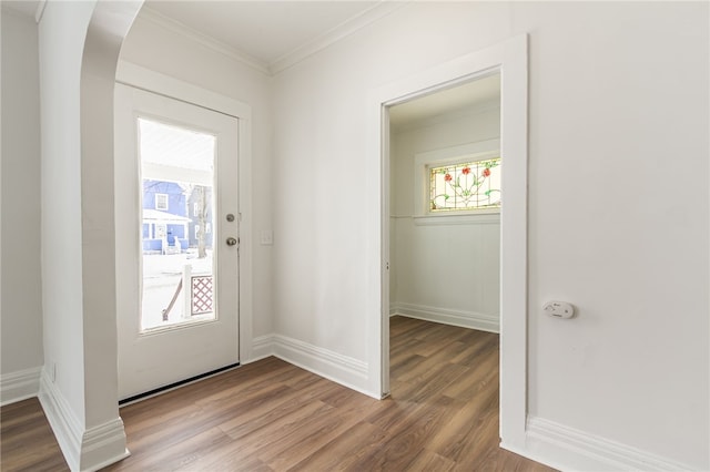 entrance foyer featuring ornamental molding and hardwood / wood-style floors