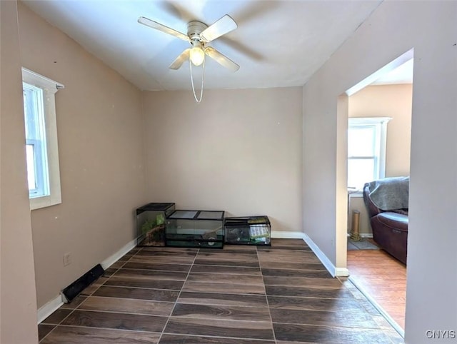 interior space featuring ceiling fan and dark hardwood / wood-style floors