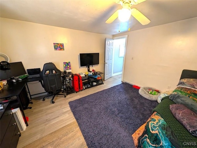 bedroom with ceiling fan and light hardwood / wood-style floors