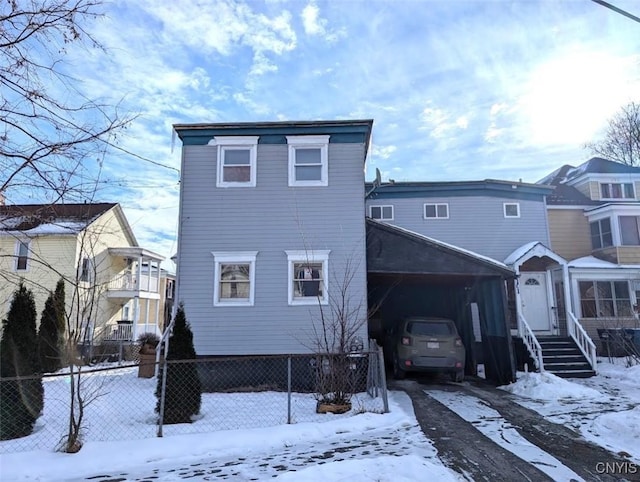 view of snow covered rear of property