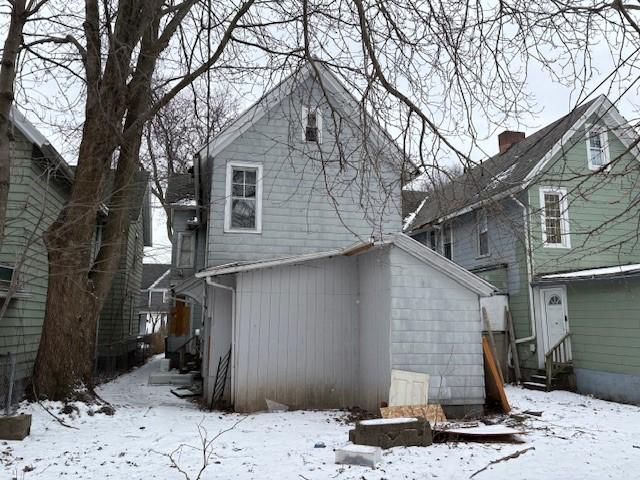 view of snow covered rear of property