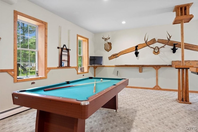 recreation room with light carpet and a baseboard heating unit