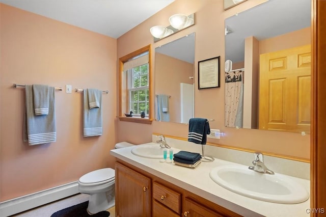 bathroom featuring a baseboard radiator, vanity, and toilet