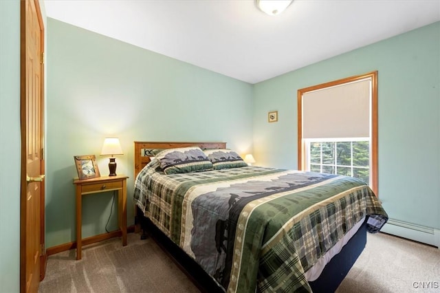 carpeted bedroom featuring a baseboard heating unit