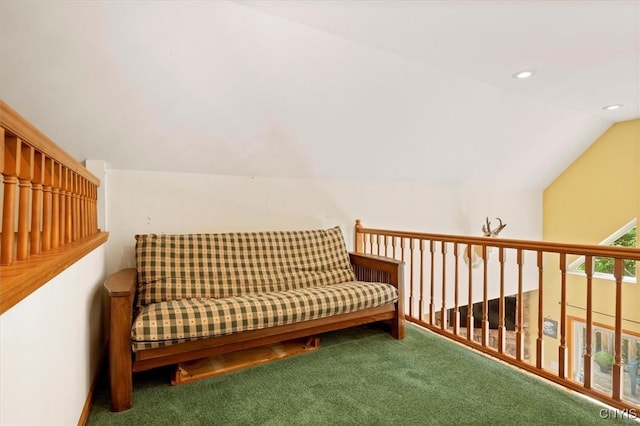 sitting room with carpet floors and vaulted ceiling