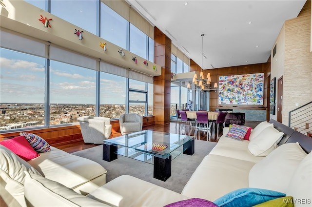 living room featuring a towering ceiling and wood walls