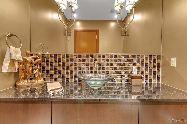 bathroom with vanity and decorative backsplash