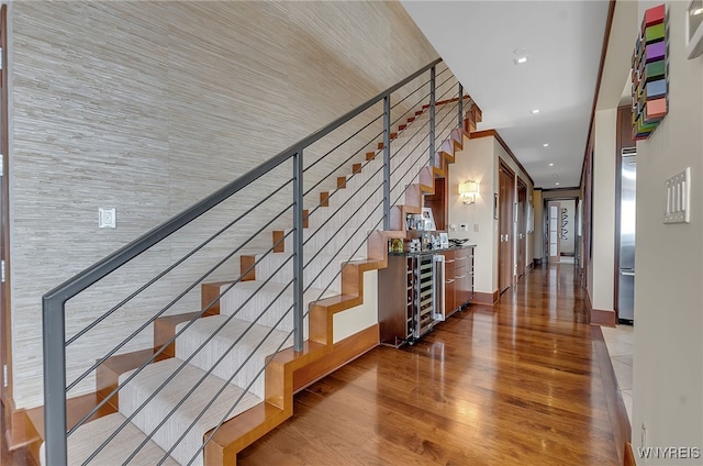 staircase with wine cooler and crown molding