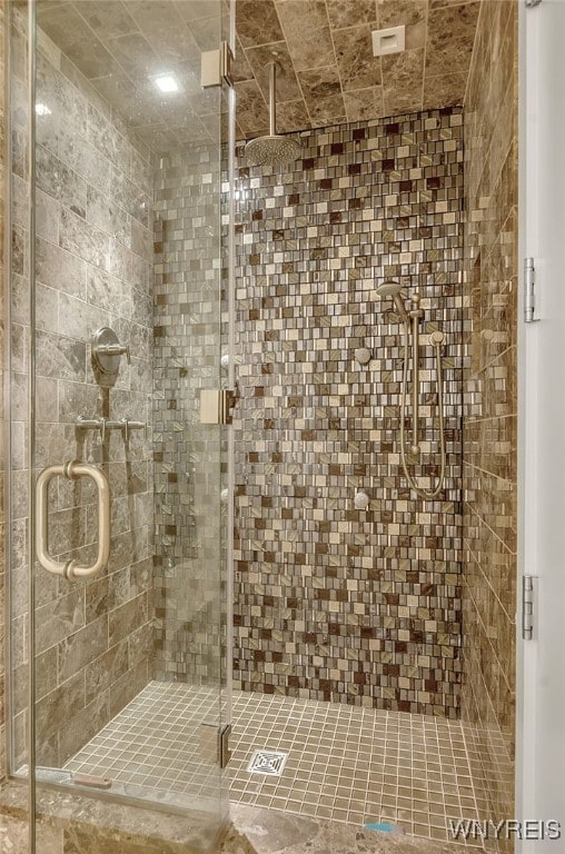 bathroom featuring a shower with shower door