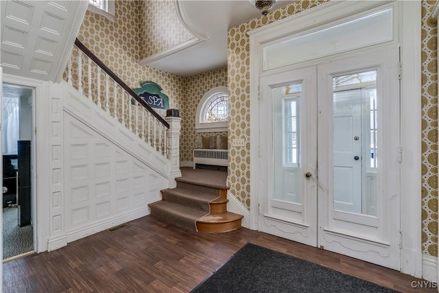 foyer featuring dark hardwood / wood-style floors and radiator heating unit