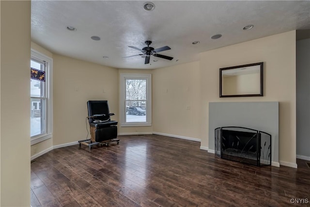 unfurnished living room with dark wood-type flooring and ceiling fan