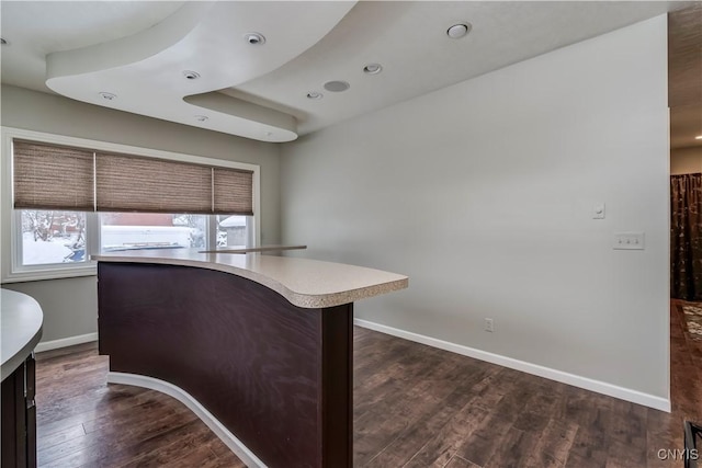 kitchen featuring plenty of natural light and dark hardwood / wood-style flooring