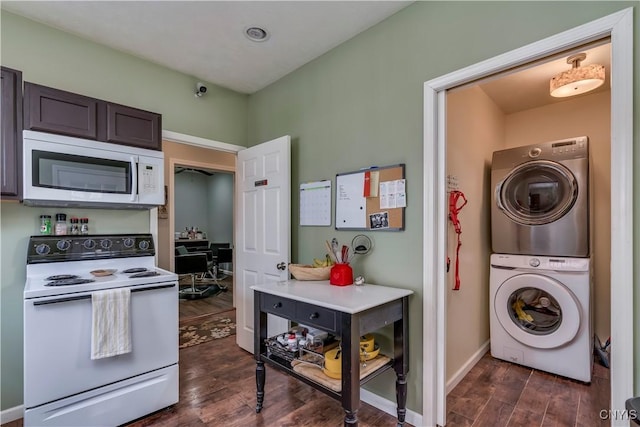 kitchen featuring dark brown cabinetry, stacked washer / drying machine, white appliances, and dark hardwood / wood-style flooring