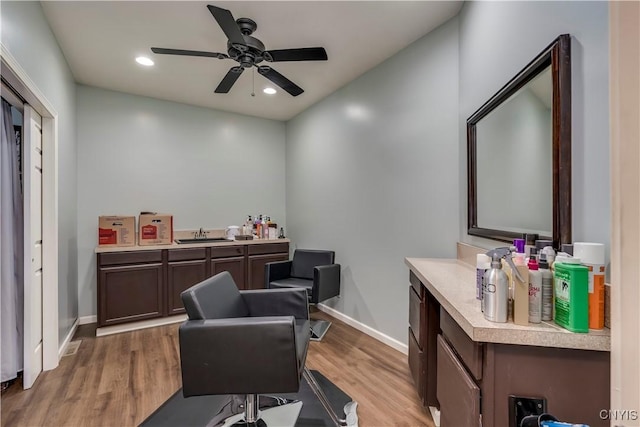 office space featuring sink, ceiling fan, and light hardwood / wood-style flooring