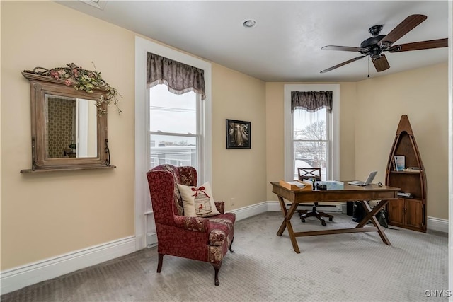 home office featuring light colored carpet and ceiling fan