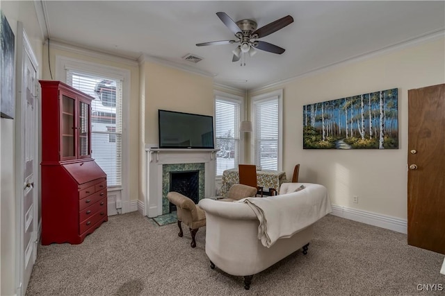 living room featuring ceiling fan, light colored carpet, ornamental molding, and a fireplace