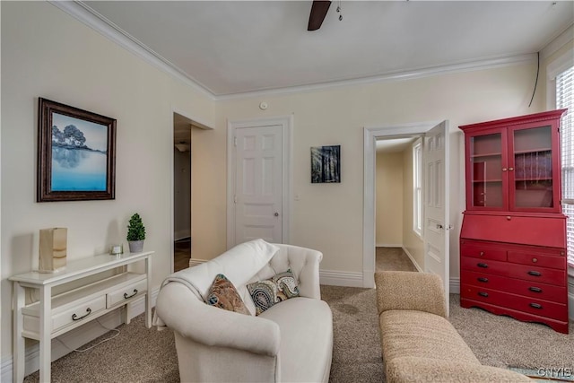 living room with ceiling fan, ornamental molding, and carpet flooring