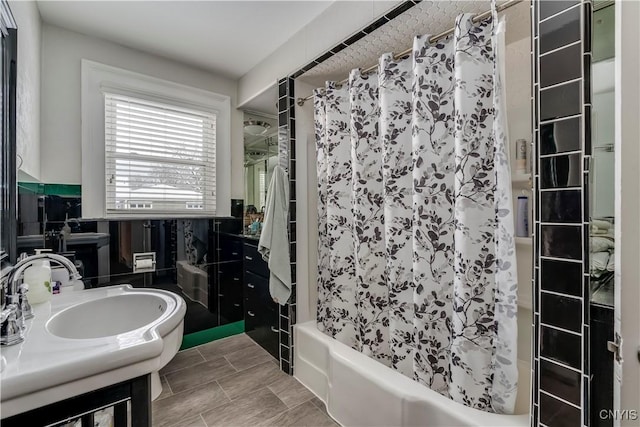 bathroom featuring vanity, tile walls, and shower / tub combo with curtain