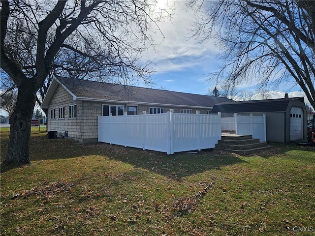 back of house featuring a garage and a yard