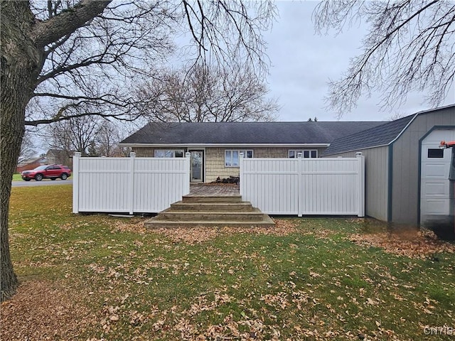 back of house with a lawn