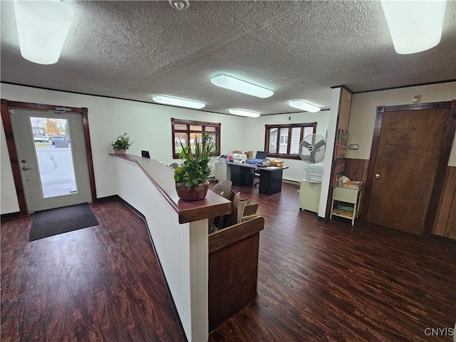 interior space featuring dark hardwood / wood-style floors and a textured ceiling