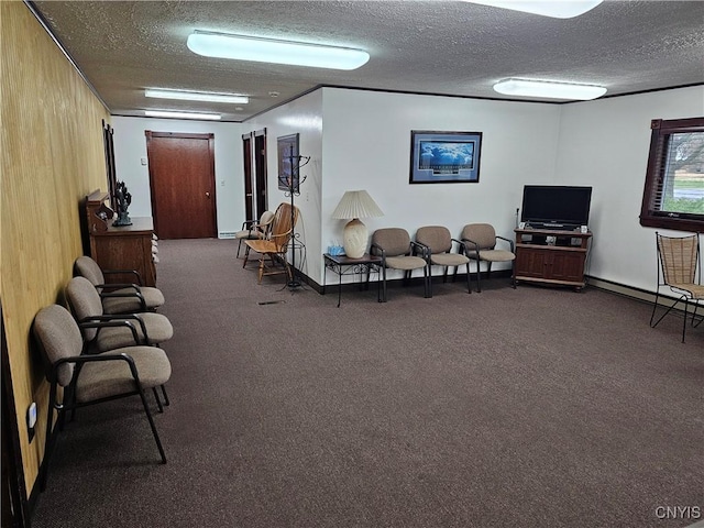 interior space featuring dark colored carpet and a textured ceiling