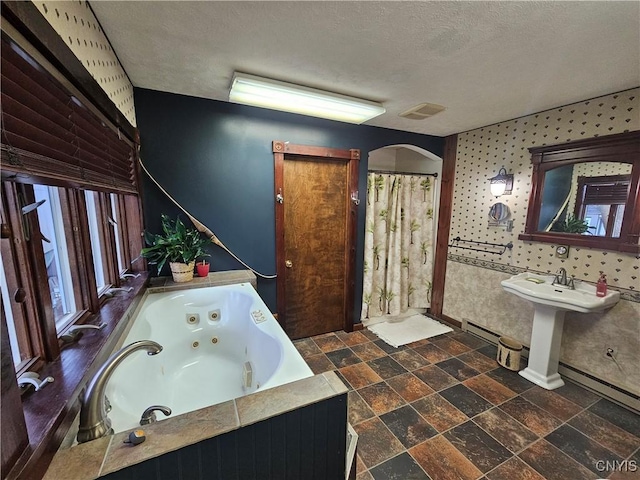 bathroom featuring a baseboard radiator, plus walk in shower, and a textured ceiling