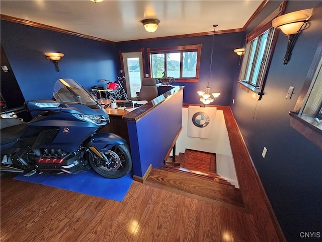 interior space with a notable chandelier, crown molding, and wood-type flooring