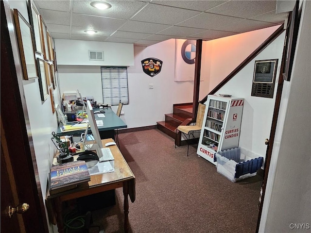 carpeted office featuring a drop ceiling