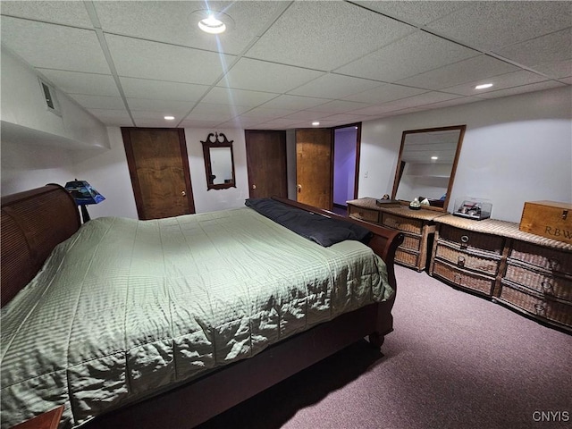 bedroom with a paneled ceiling and carpet flooring