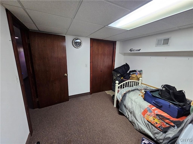 carpeted bedroom featuring a paneled ceiling