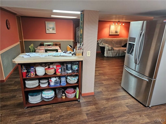 kitchen featuring dark hardwood / wood-style flooring and stainless steel fridge with ice dispenser