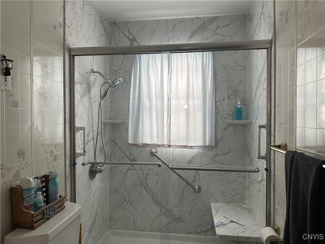 bathroom featuring an enclosed shower and toilet