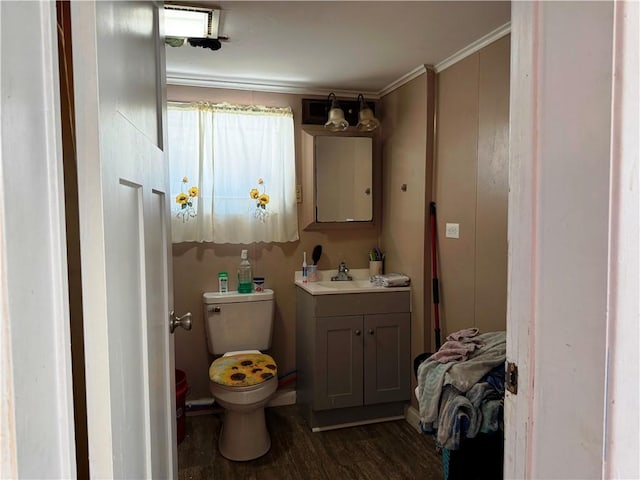 bathroom with vanity, wood-type flooring, ornamental molding, and toilet