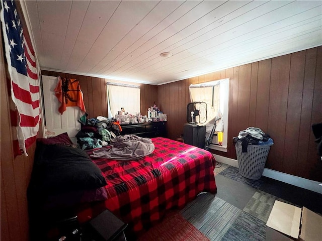 bedroom featuring wood walls