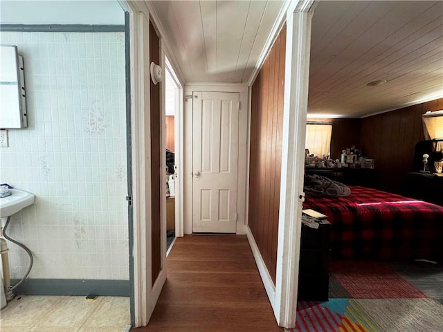 hallway featuring dark hardwood / wood-style floors and wooden ceiling