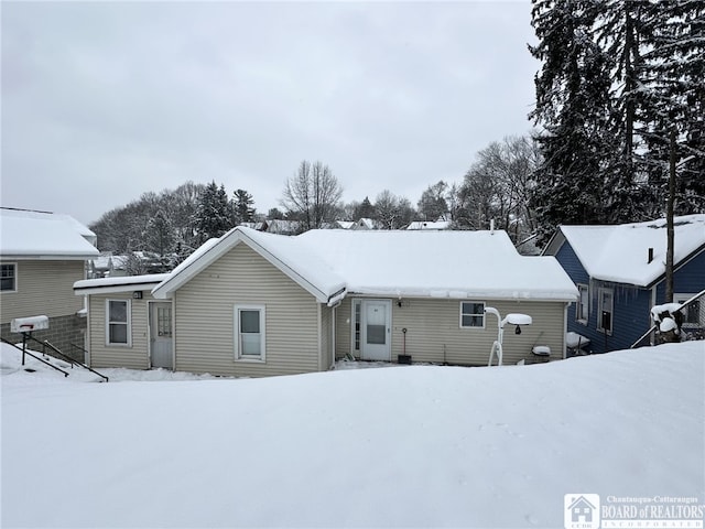 view of snow covered back of property