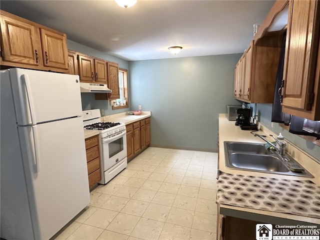 kitchen featuring white appliances and sink