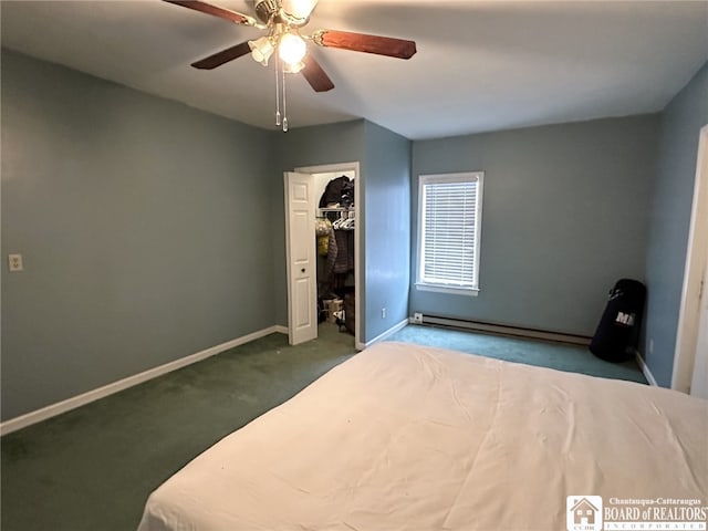 unfurnished bedroom featuring a spacious closet, baseboard heating, carpet floors, a closet, and ceiling fan