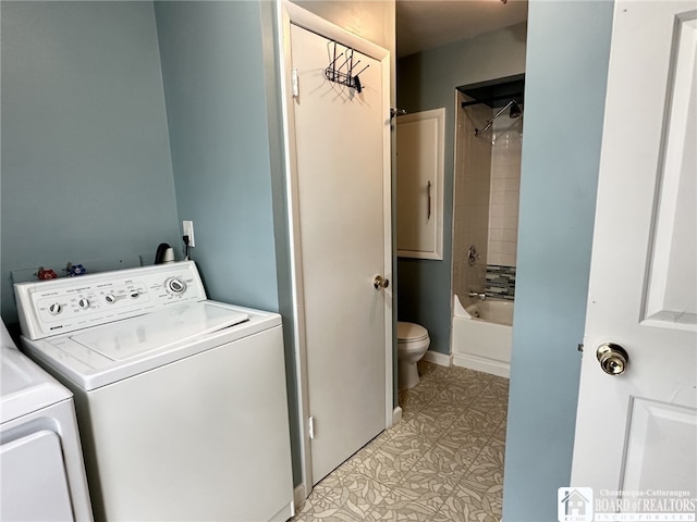 clothes washing area with light tile patterned floors and washer and dryer