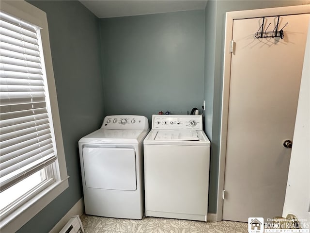 laundry area with washing machine and dryer, light tile patterned floors, and a baseboard radiator