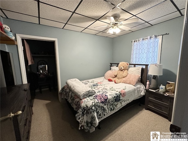 carpeted bedroom featuring a paneled ceiling and ceiling fan