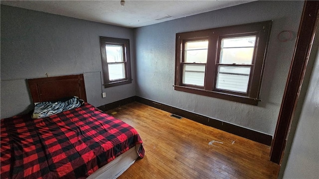 bedroom with hardwood / wood-style flooring