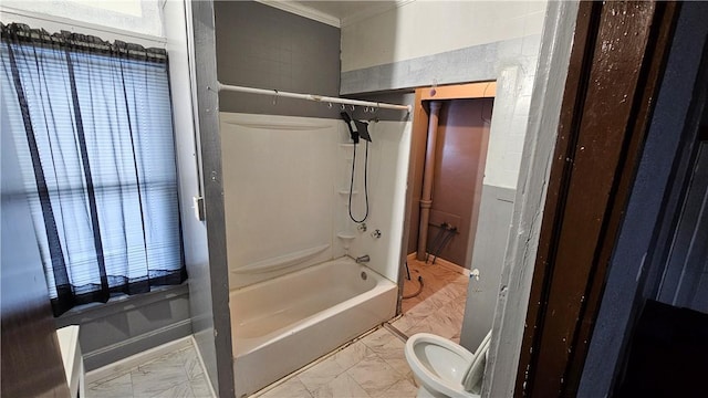 bathroom featuring ornamental molding, tub / shower combination, and toilet